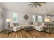 A spacious living room with plush seating, large windows, and stylish decor, creating a comfortable and inviting space at 8492 Hartford Way, Mount Dora, FL 32757