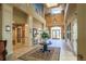 Stunning two-story lobby featuring a large round table, elegant chandelier, and ample natural light at 8492 Hartford Way, Mount Dora, FL 32757