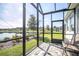 Serene screened patio with views of the pond, inviting outdoor relaxation and enjoyment at 8492 Hartford Way, Mount Dora, FL 32757