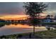 Picturesque sunset view of the pond, reflecting vibrant colors and creating a peaceful ambiance at 8492 Hartford Way, Mount Dora, FL 32757