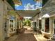 Charming outdoor shopping center featuring unique boutiques and lush landscaping at 8492 Hartford Way, Mount Dora, FL 32757