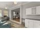 Comfortable sitting area with desk, view into the living room, and white cabinets at 8492 Hartford Way, Mount Dora, FL 32757