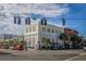 Corner view of a light colored building at a street intersection with palm trees and vintage streetlights at 8492 Hartford Way, Mount Dora, FL 32757