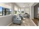 Bright, tiled sunroom featuring dual chairs and scenic views of the surrounding landscape and bodies of water at 8492 Hartford Way, Mount Dora, FL 32757