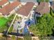 Aerial perspective of property, highlighting backyard patio and established trees at 919 Medira Dr, The Villages, FL 32159
