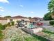 Backyard showcasing patio, outdoor seating, and fire pit with rock landscaping at 919 Medira Dr, The Villages, FL 32159