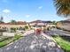 Expansive backyard with patio area, outdoor seating, fire pit, and established landscaping at 919 Medira Dr, The Villages, FL 32159