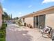 Backyard patio with sliding glass doors and seating area; lush landscaping and privacy fence at 919 Medira Dr, The Villages, FL 32159
