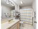 Bathroom with a single sink vanity, shower-tub combination, and modern lighting at 919 Medira Dr, The Villages, FL 32159