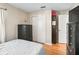 Cozy bedroom featuring hardwood floors, neutral walls, closet and modern black dresser at 919 Medira Dr, The Villages, FL 32159