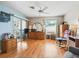 A bright bedroom with light walls, hard wood floors, dresser and ceiling fan at 919 Medira Dr, The Villages, FL 32159