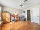 A bright bedroom with light walls, hard wood floors, closet and ceiling fan at 919 Medira Dr, The Villages, FL 32159