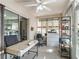 Bright office with tiled floors, ceiling fan, shelving and door to the backyard at 919 Medira Dr, The Villages, FL 32159