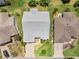 Overhead view of house showing the roof, driveway, and landscaping at 951 Chapman Loop, The Villages, FL 32162