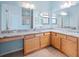 Spacious bathroom featuring double sinks, granite countertops, wood cabinets and tiled shower at 951 Chapman Loop, The Villages, FL 32162