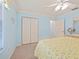 Bedroom featuring a closet, neutral carpet, and serene blue walls at 951 Chapman Loop, The Villages, FL 32162
