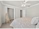 Cozy bedroom featuring a ceiling fan, closet, and neutral decor with white trim at 951 Chapman Loop, The Villages, FL 32162