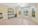 Inviting dining area featuring tile floors, natural light, and a decorative baker's rack at 951 Chapman Loop, The Villages, FL 32162