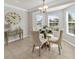 Cozy dining area with large windows allowing natural light and tile flooring at 951 Chapman Loop, The Villages, FL 32162