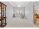 Formal dining room with elegant chandelier, carpet, and cabinet for storage and display at 951 Chapman Loop, The Villages, FL 32162