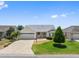 Charming one-story home with well-manicured lawn, concrete driveway, and attached two-car garage at 951 Chapman Loop, The Villages, FL 32162