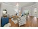 Spacious living room with wood floors, comfortable seating, and an open layout at 951 Chapman Loop, The Villages, FL 32162