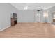 Large living room with wood floors, ceiling fan, and glass sliding door to the enclosed patio at 951 Chapman Loop, The Villages, FL 32162