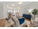 Inviting living room with hardwood floors, stylish furniture, and a decorative blue cabinet at 951 Chapman Loop, The Villages, FL 32162