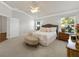 Comfortable main bedroom with soft carpet, a tufted headboard, and natural light at 951 Chapman Loop, The Villages, FL 32162
