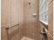 Walk-in shower featuring neutral tiling and a glass block window for natural light at 951 Chapman Loop, The Villages, FL 32162
