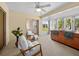 Inviting sunroom with a ceiling fan, comfortable seating, and sliding glass doors at 951 Chapman Loop, The Villages, FL 32162