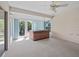 Enclosed sunroom featuring a hot tub, large windows, and outdoor access at 951 Chapman Loop, The Villages, FL 32162