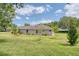 Expansive backyard featuring a well-maintained lawn, lush landscaping, and potential for outdoor activities and relaxation at 987 Princeton Dr, Clermont, FL 34711