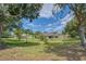 Large backyard framed by mature trees, providing a private and tranquil outdoor space for Gathering and gatherings at 987 Princeton Dr, Clermont, FL 34711
