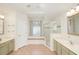 Bright bathroom featuring double sinks, a walk-in shower, and a soaking tub at 987 Princeton Dr, Clermont, FL 34711