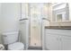 Modern bathroom with granite counters, glass shower stall, and clean, bright fixtures, offering a spa-like experience at 987 Princeton Dr, Clermont, FL 34711