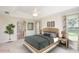This spacious bedroom features a tray ceiling, ceiling fan, and en suite bathroom at 987 Princeton Dr, Clermont, FL 34711