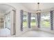 Bright breakfast nook with tile floors, large windows with decorative curtains, and views of the outdoors at 987 Princeton Dr, Clermont, FL 34711