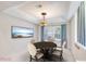 Cozy dining room with a round table, elegant chandelier, and bright window views at 987 Princeton Dr, Clermont, FL 34711