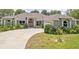 Charming single-story home featuring a circular driveway and well-manicured landscaping at 987 Princeton Dr, Clermont, FL 34711