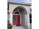 Close up of the main entry featuring double glass doors, an arched entryway, and stylish lighting at 987 Princeton Dr, Clermont, FL 34711