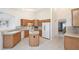 Spacious kitchen with an island, tiled backsplash, and white appliances at 987 Princeton Dr, Clermont, FL 34711