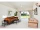 Inviting living room with neutral carpet, a ceiling fan, and a sliding glass door at 987 Princeton Dr, Clermont, FL 34711