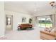 Bright living room with neutral carpet and a sliding glass door to the backyard at 987 Princeton Dr, Clermont, FL 34711