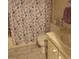 A bathroom featuring a toilet, sink and bathtub behind a shower curtain with sea-themed design at 1014 Dustin Dr, Lady Lake, FL 32159