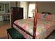 Cozy bedroom featuring a queen-sized bed, hardwood floors, and mirrored closet doors at 1014 Dustin Dr, Lady Lake, FL 32159