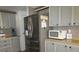 Well-equipped kitchen with stainless steel refrigerator, built-in microwave, and ample cabinet space at 1014 Dustin Dr, Lady Lake, FL 32159