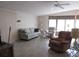 Bright living room with neutral tones, featuring comfortable seating and ample natural light at 1014 Dustin Dr, Lady Lake, FL 32159