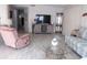 Comfortable living room featuring a plush recliner, striped sofa, and a glass-top coffee table at 1014 Dustin Dr, Lady Lake, FL 32159