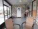An enclosed patio space with textured stone walls, seating area and a door leading to the outside at 1014 Dustin Dr, Lady Lake, FL 32159
